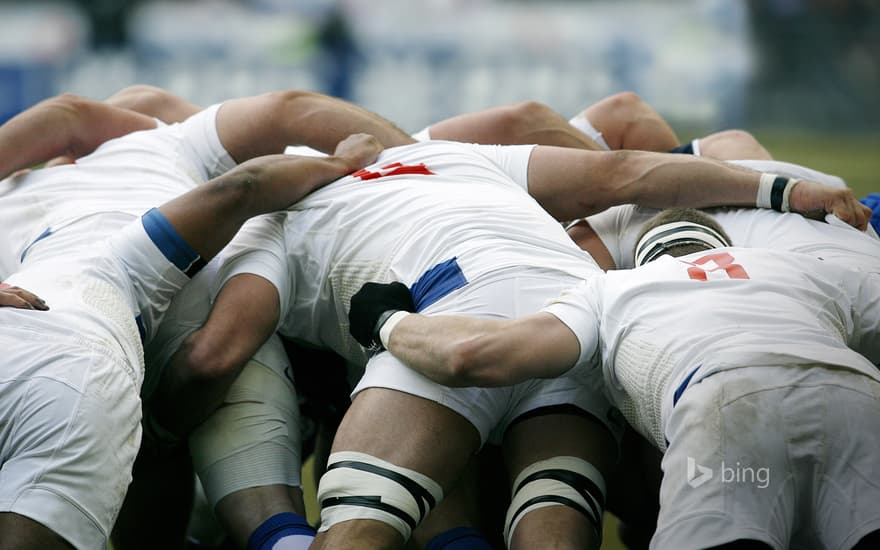 Rugby union players battle for the ball in a scrum